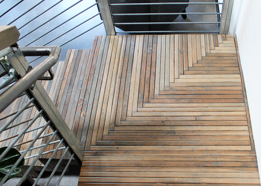 A top-down view of the nail-laminated timber staircase showcasing the vinegar washed planks and herringbone design